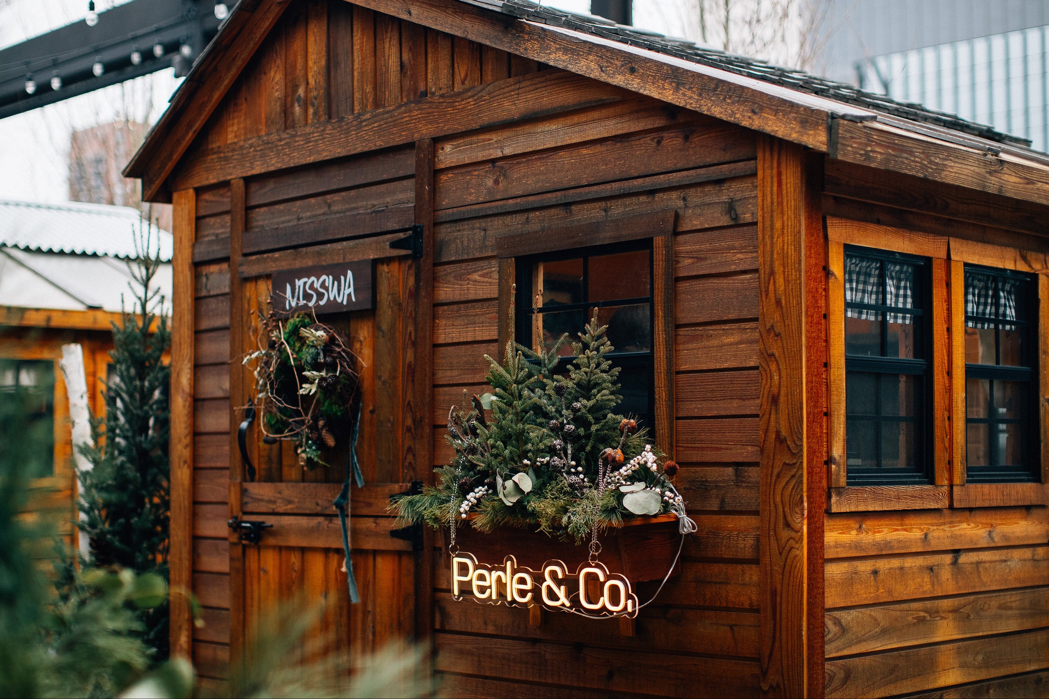 Wooden cabin with decorative elements and signs on a blurred background